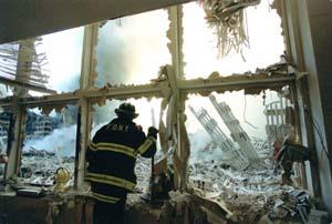 Firefighter looks out window at Ground Zero. Photo, Jim MacMillan, Daily News